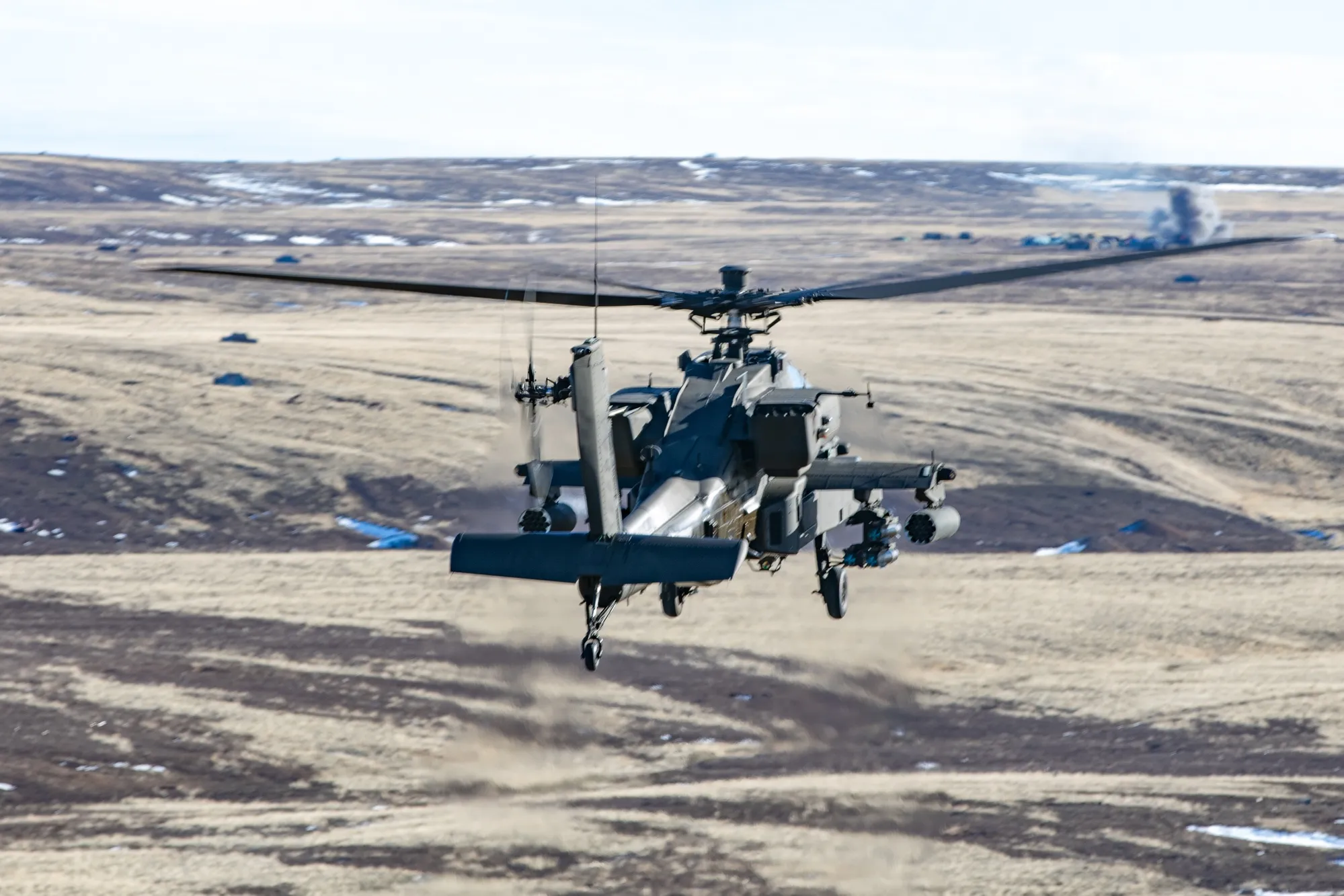 AH-64E Apache head-on with rotor wash and target explosion